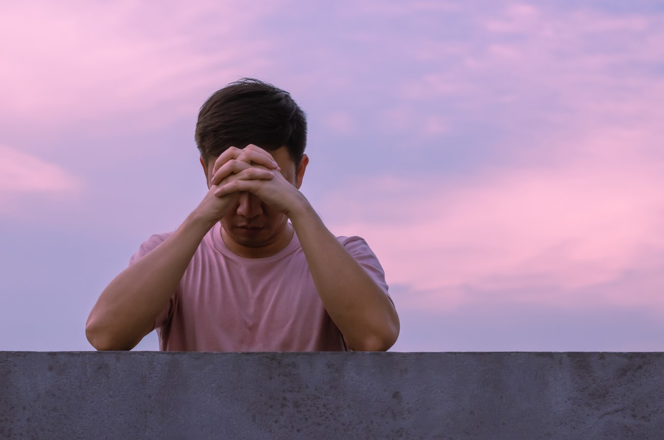 Asian miserable depressed man stay alone with sky background. De