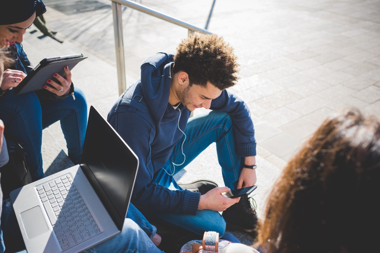 Multiracial group young people using technology