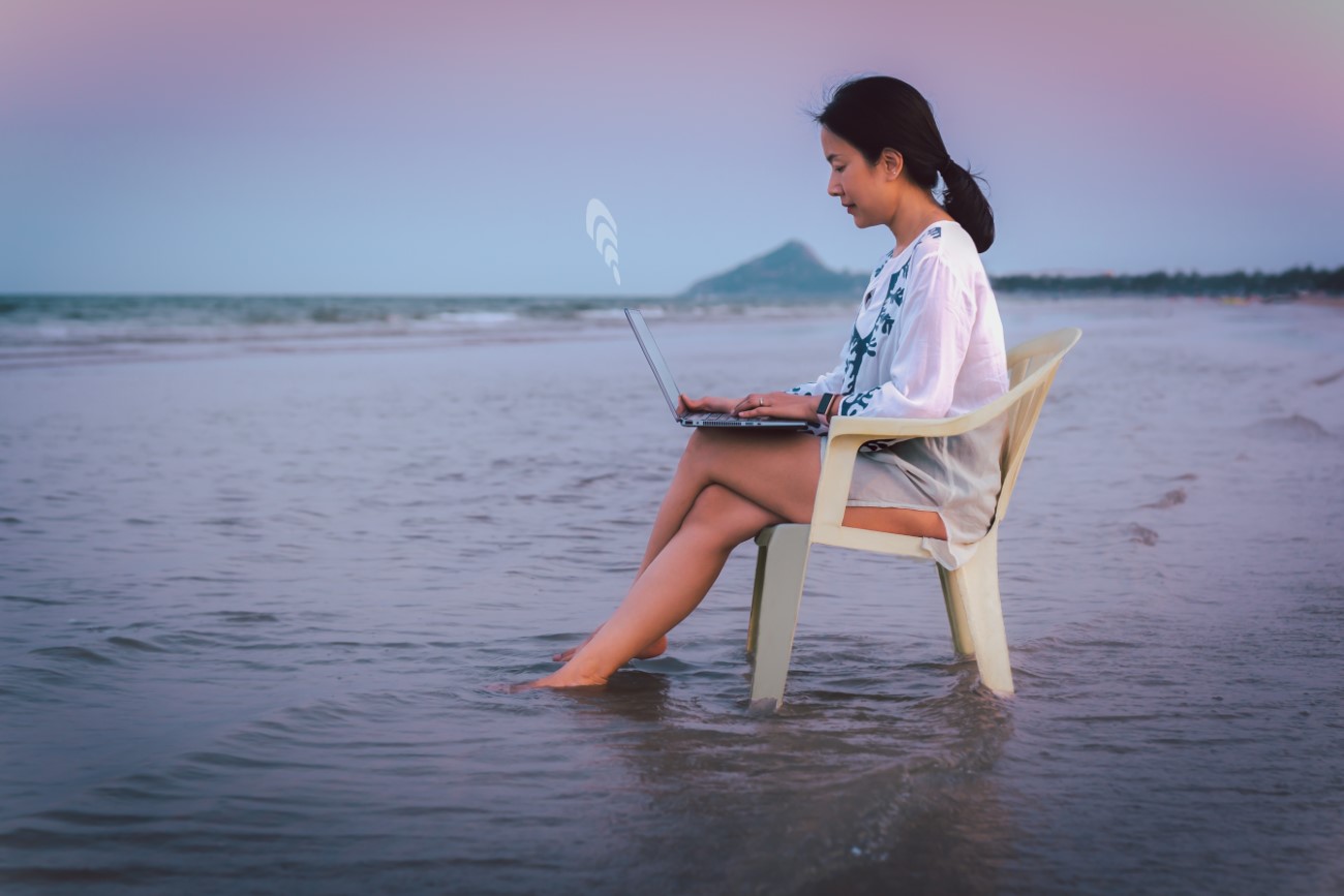 Side view businesswoman using laptop while sitting in a chaie on