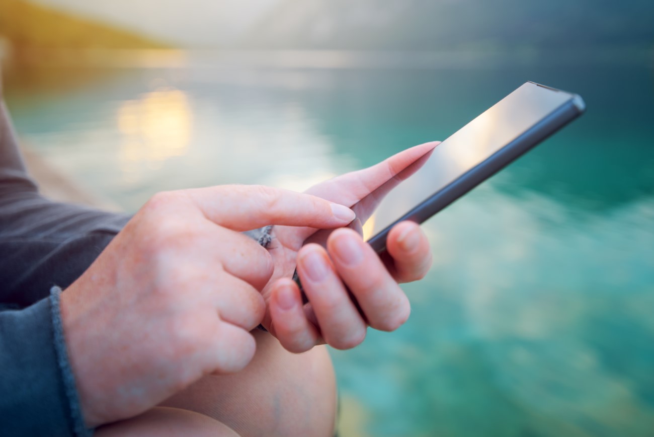 Woman using mobile phone outdoors in nature